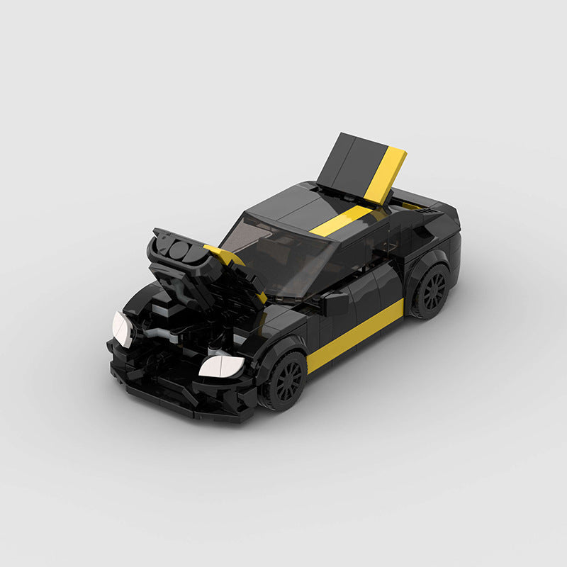 Black and yellow toy car model on a light gray background